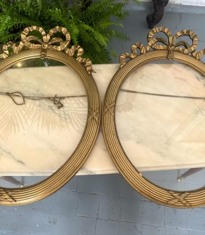 Antique pair of French oval gilt wood frames with ribbon decor