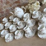 grand antique porcelain tea and coffee service with pink floral pattern and ornate gold handles for sixteen persons