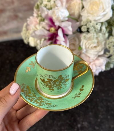 Spectacular antique french porcelain cup and saucer hand-decorated in a radiant empire green glaze with exquisite 24k gold leaf floral gilding