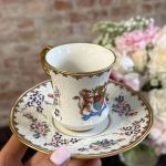 antique armorial porcelain cup and saucer with coat of arms and raised white enamel