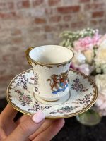 antique armorial porcelain cup and saucer with coat of arms and raised white enamel