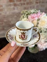 Antique French porcelain espresso cup and saucer with white relief slip barbotine and coat of arms