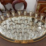 Antique French Baccarat style crystal stemware collection featuring four distinct sizes with elegant hand-painted geometric gold gilt rims.