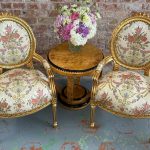 antique gilded armchairs with floral upholstery duo