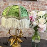 Antique style gilt metal table lamp with green velvet shade and floral base