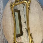 Ornate gilt rococo wall mirror in Louis XV style with floral motifs