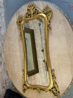 Ornate gilt rococo wall mirror in Louis XV style with floral motifs