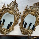 Pair of heavy gilt rococo mirrored wall sconces with beveled glass and female busts