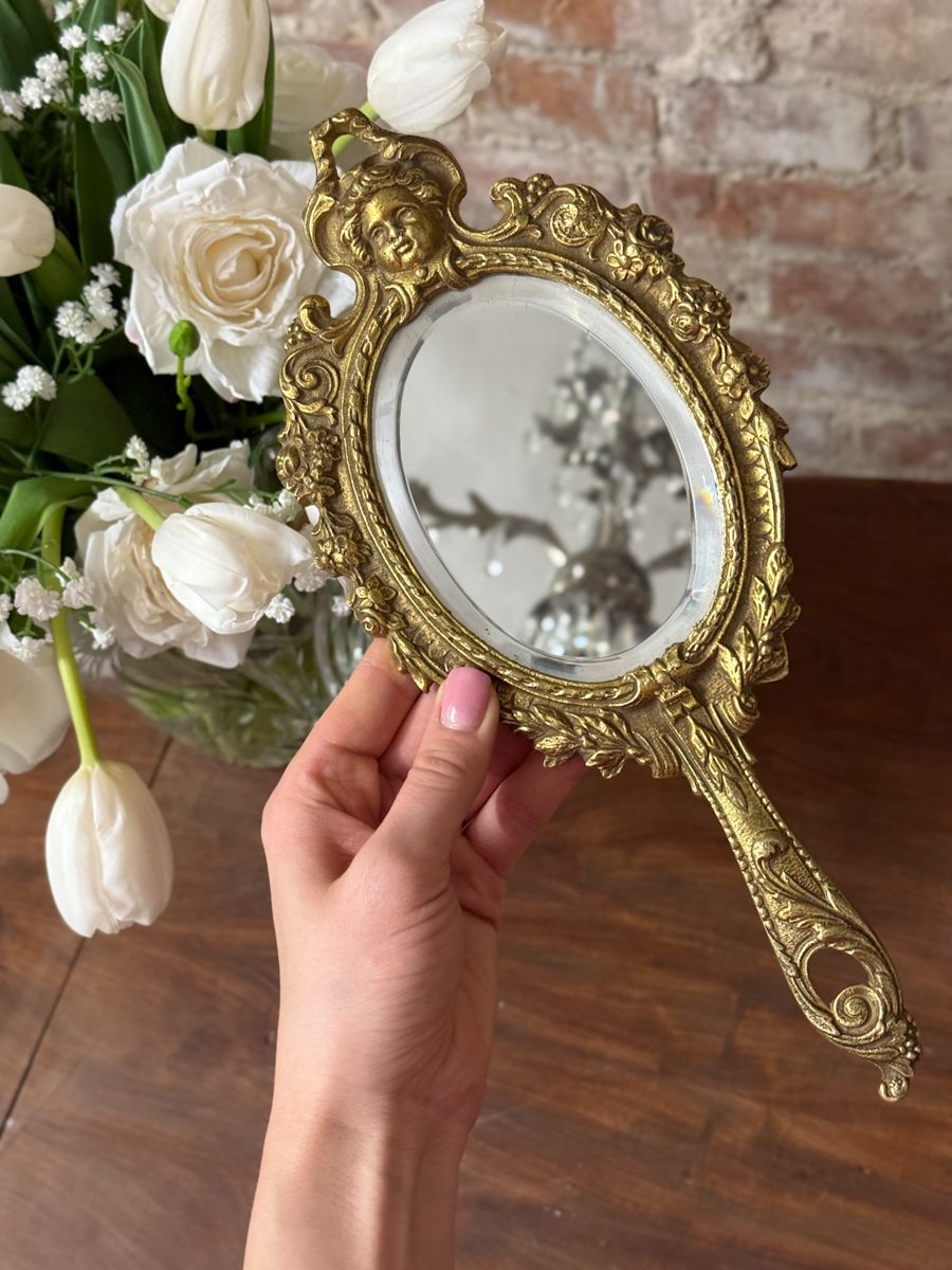gilt bronze hand mirror with cherub