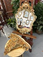 Elegant rococo revival mirror and console table with ornate floral frame