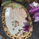 Antique French Louis XV style gilt bronze oval wall mirror featuring ornate scrolling openwork