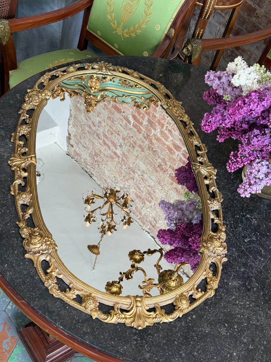 Antique French Louis XV style gilt bronze oval wall mirror featuring ornate scrolling openwork