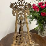 Antique German Jugendstil brass tabletop easel with ornate pierced openwork featuring structural iris blossoms and scrolling organic tendrils.