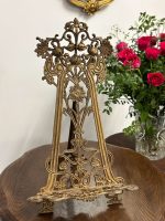 Antique German Jugendstil brass tabletop easel with ornate pierced openwork featuring structural iris blossoms and scrolling organic tendrils.