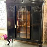 Large black wooden vitrine cabinet with curved glass