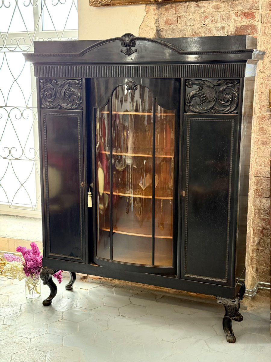Large black wooden vitrine cabinet with curved glass