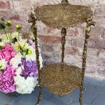 Pierced brass two-tier plant stand with rococo openwork shelves and vine legs
