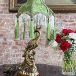 Antique desk lamp with peacock base and green velvet fringed shade