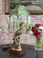 Antique desk lamp with peacock base and green velvet fringed shade