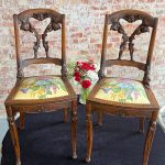 Pair of French Art Nouveau carved oak side chairs with floral upholstery and mascaron legs