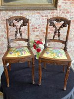 Pair of French Art Nouveau carved oak side chairs with floral upholstery and mascaron legs
