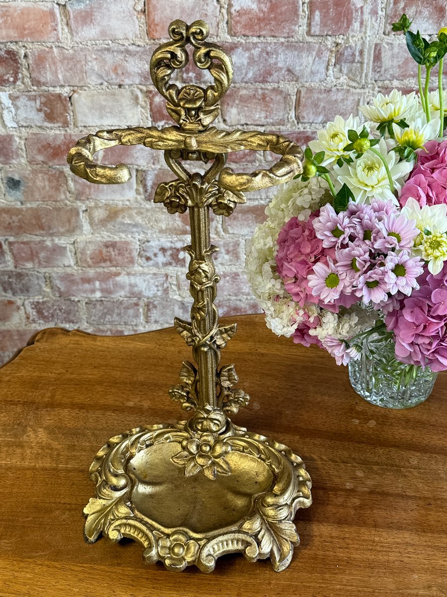 IMG_8086 Antique French Victorian style gold patinated cast iron umbrella stand featuring a detailed rococo scrollwork frame and a removable drip tray base.