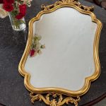 gilt rococo wall mirror with carved acanthus crest in louis xv style