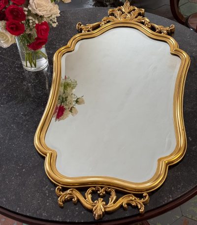 gilt rococo wall mirror with carved acanthus crest in louis xv style