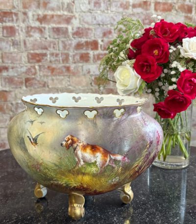 Antique hand-painted limoges porcelain cachepot featuring a hunting dog setter and flying duck motif with gold rocaille feet in Neo-Rococo style.