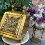 Antique brass coal scuttle with repoussé griffin panel and shovel