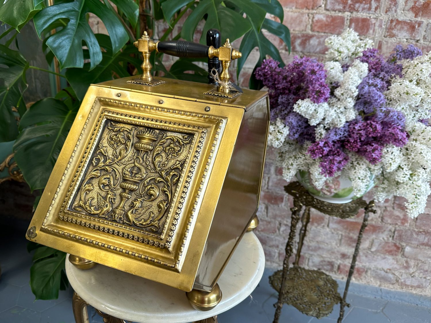 Antique brass coal scuttle with repoussé griffin panel and shovel