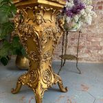 Carved giltwood pedestal with four caryatid figures and rococo floral ornament