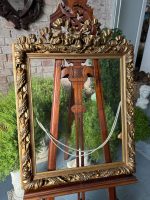 Antique gilt picture frame with bow cresting and historic glass
