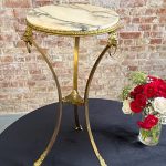 Tall brass and marble side table with lion heads