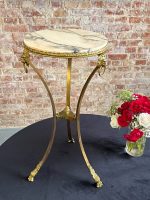 Tall brass and marble side table with lion heads