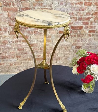 Tall brass and marble side table with lion heads